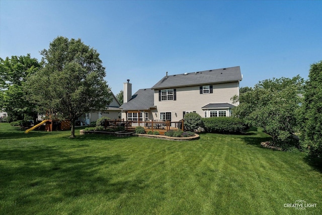 439 Camden Cir, Oswego, IL 60543 - rear view of house featuring a lawn, a chimney, a playground, and a wooden deck