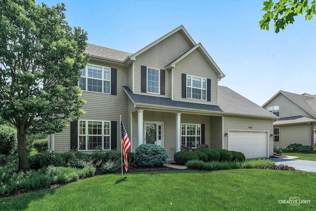 439 Camden Cir, Oswego, IL 60543 - traditional-style home with an attached garage, concrete driveway, a front yard, and a porch