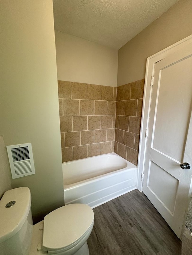 153 N Entrance Ave, Kankakee, IL 60901 - bathroom featuring wood finished floors, a tub to relax in, and a textured ceiling