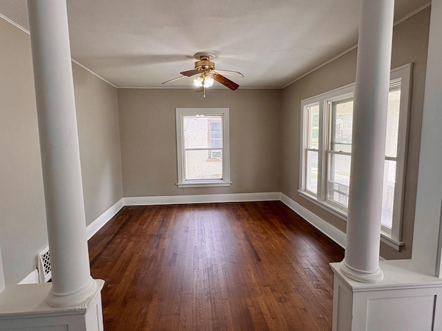 153 N Entrance Ave, Kankakee, IL 60901 - spare room featuring decorative columns, dark wood-style flooring, a ceiling fan, and crown molding