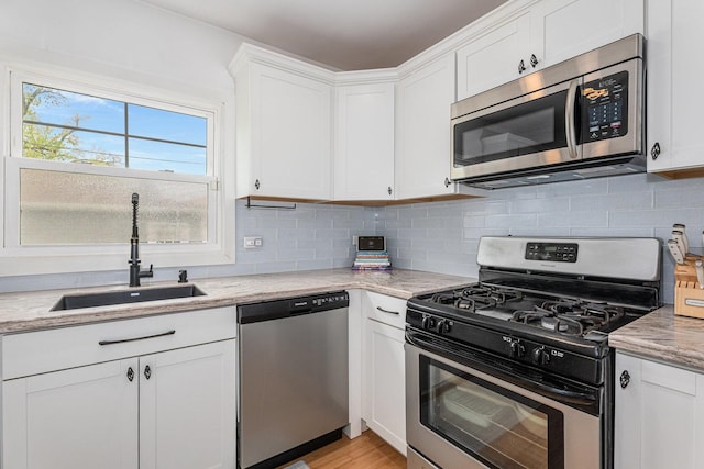 3618 178th St, Lansing, IL 60438 - kitchen with stainless steel appliances, a sink, white cabinetry, tasteful backsplash, and light stone countertops