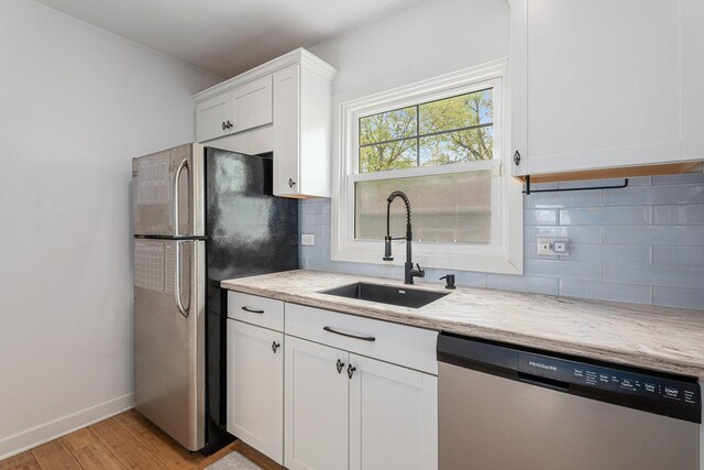 3618 178th St, Lansing, IL 60438 - kitchen featuring appliances with stainless steel finishes, a sink, white cabinets, and decorative backsplash
