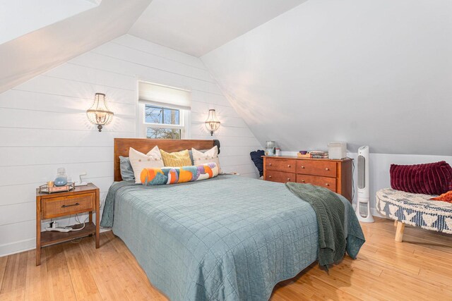 3618 178th St, Lansing, IL 60438 - bedroom with vaulted ceiling, light wood-style flooring, and wooden walls