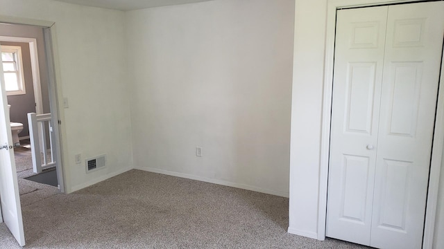402 W Fulton St, Polo, IL 61064 - unfurnished bedroom featuring carpet, a closet, and baseboards