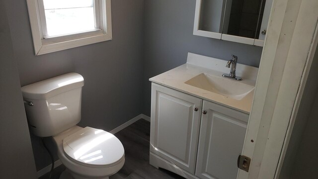 402 W Fulton St, Polo, IL 61064 - bathroom featuring vanity, toilet, and baseboards