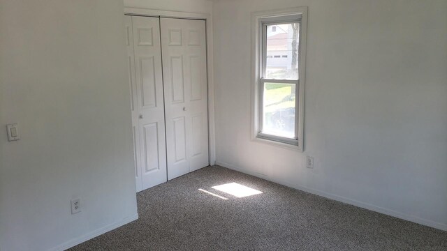 402 W Fulton St, Polo, IL 61064 - unfurnished bedroom featuring carpet flooring, a closet, and baseboards