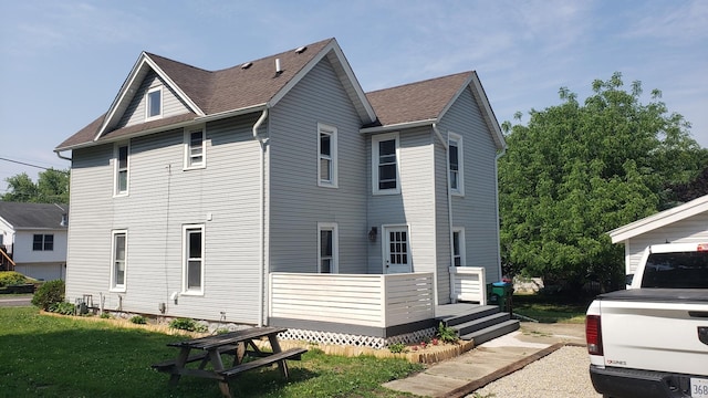 402 W Fulton St, Polo, IL 61064 - view of side of property with a wooden deck, a lawn, and a shingled roof