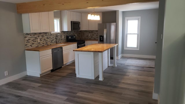 402 W Fulton St, Polo, IL 61064 - kitchen with butcher block countertops, appliances with stainless steel finishes, a sink, and white cabinetry