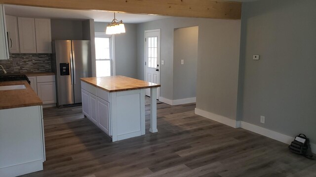 402 W Fulton St, Polo, IL 61064 - kitchen with stainless steel fridge with ice dispenser, butcher block counters, decorative backsplash, and baseboards