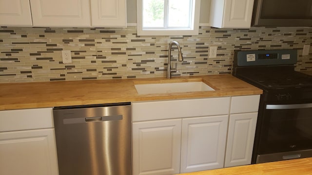 402 W Fulton St, Polo, IL 61064 - kitchen with appliances with stainless steel finishes, butcher block counters, a sink, white cabinets, and tasteful backsplash