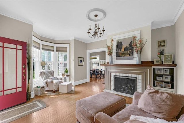 320 E Locust St, Watseka, IL 60970 - living room with ornamental molding, wood finished floors, a chandelier, and a brick fireplace