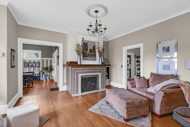 320 E Locust St, Watseka, IL 60970 - living area featuring a chandelier, crown molding, wood finished floors, and a brick fireplace