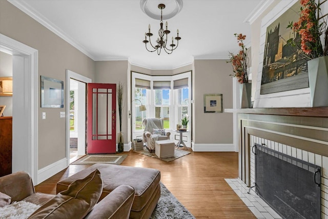 320 E Locust St, Watseka, IL 60970 - entryway featuring a chandelier, wood finished floors, a fireplace with flush hearth, and ornamental molding