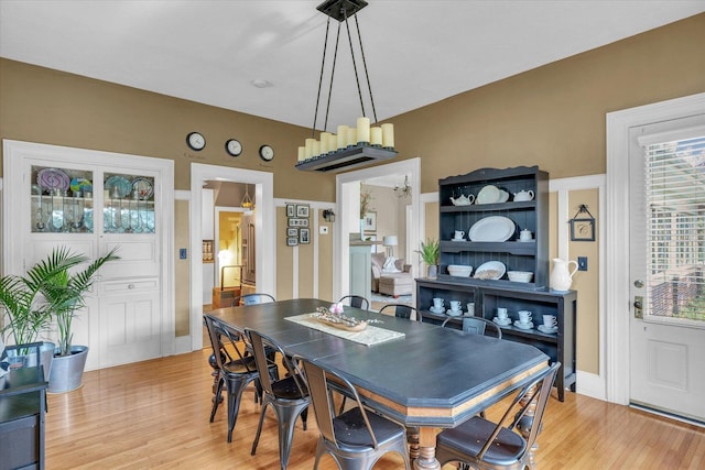 320 E Locust St, Watseka, IL 60970 - dining space with light wood-type flooring and a chandelier
