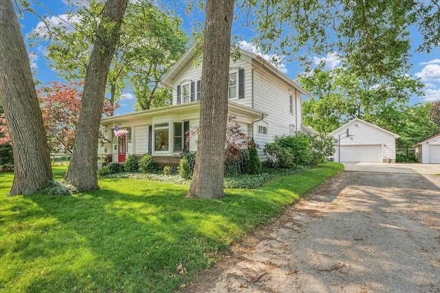 320 E Locust St, Watseka, IL 60970 - view of front facade with an outbuilding, a garage, and a front yard