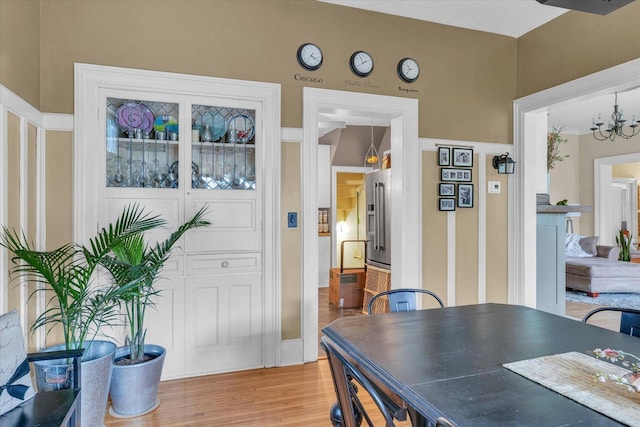 320 E Locust St, Watseka, IL 60970 - dining space with light wood finished floors and a chandelier
