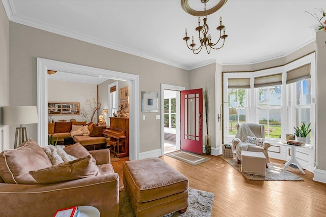 320 E Locust St, Watseka, IL 60970 - living area featuring light wood-style flooring, crown molding, and a chandelier
