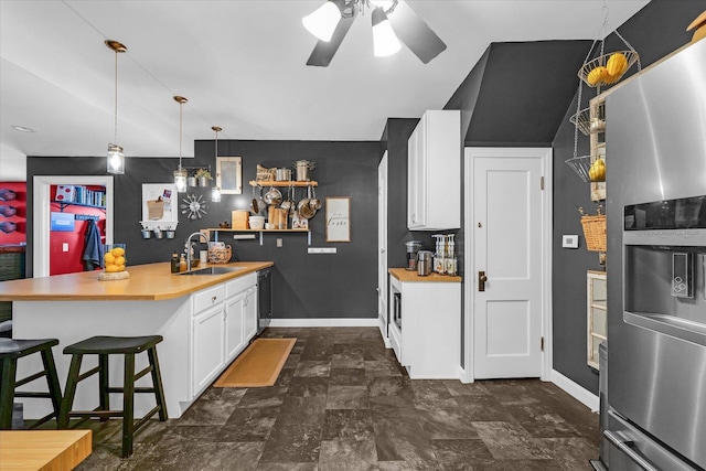 320 E Locust St, Watseka, IL 60970 - kitchen with stainless steel refrigerator with ice dispenser, a peninsula, light countertops, and white cabinetry