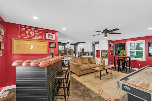 320 E Locust St, Watseka, IL 60970 - living room featuring a ceiling fan, a bar, and recessed lighting