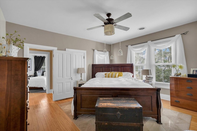 320 E Locust St, Watseka, IL 60970 - bedroom with light wood finished floors and a ceiling fan