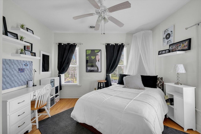 320 E Locust St, Watseka, IL 60970 - bedroom with light wood-style floors, ceiling fan, and built in desk