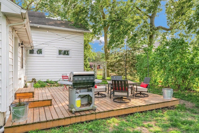 320 E Locust St, Watseka, IL 60970 - wooden deck with outdoor dining space and area for grilling