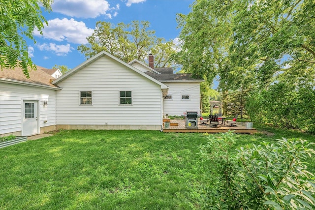 320 E Locust St, Watseka, IL 60970 - rear view of property with a wooden deck, a lawn, and a chimney