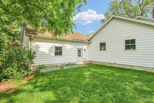 320 E Locust St, Watseka, IL 60970 - rear view of house with a lawn and roof with shingles