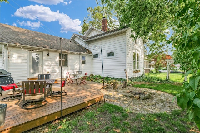 320 E Locust St, Watseka, IL 60970 - rear view of house featuring outdoor dining area, a chimney, and a deck