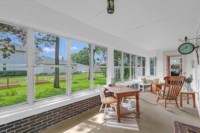 320 E Locust St, Watseka, IL 60970 - sunroom / solarium featuring healthy amount of natural light, brick wall, and concrete flooring