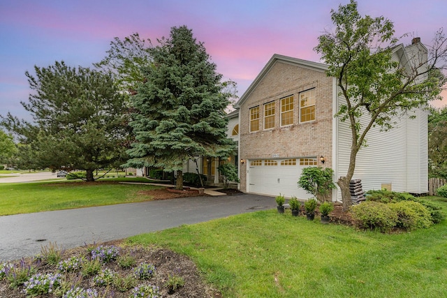 2015 Steward Ln, Plainfield, IL 60586 - view of side of home with a garage, driveway, brick siding, and a lawn
