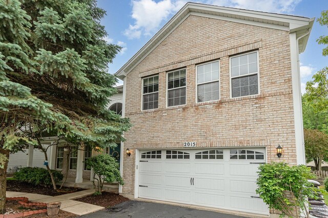 2015 Steward Ln, Plainfield, IL 60586 - view of front of house featuring brick siding, a garage, and asphalt driveway