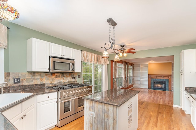2015 Steward Ln, Plainfield, IL 60586 - kitchen with stainless steel appliances, ceiling fan, white cabinets, a sink, and backsplash