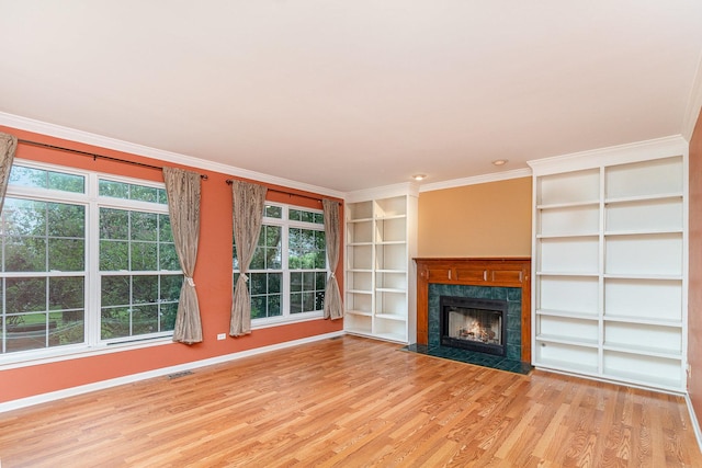 2015 Steward Ln, Plainfield, IL 60586 - unfurnished living room with light wood-style floors, crown molding, a premium fireplace, built in shelves, and baseboards