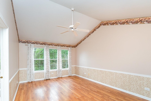 2015 Steward Ln, Plainfield, IL 60586 - unfurnished room with wallpapered walls, ceiling fan, lofted ceiling, light wood-style floors, and baseboards