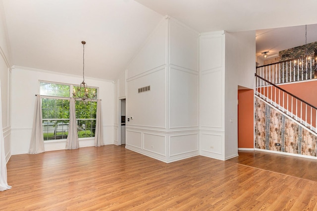 2015 Steward Ln, Plainfield, IL 60586 - unfurnished living room featuring a chandelier, light wood finished floors, and high vaulted ceiling