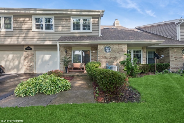 1959 Lancaster Ct Unit 4, Naperville, IL 60565 - view of front of property featuring brick siding, a front yard, driveway, an attached garage, and a chimney