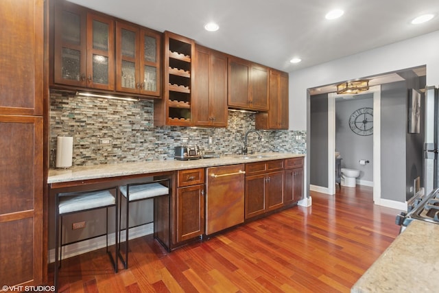 1959 Lancaster Ct Unit 4, Naperville, IL 60565 - kitchen with stainless steel dishwasher, decorative backsplash, dark wood-style flooring, glass insert cabinets, and light stone countertops
