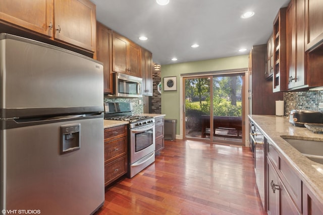 1959 Lancaster Ct Unit 4, Naperville, IL 60565 - kitchen featuring stainless steel appliances, tasteful backsplash, wood finished floors, recessed lighting, and light stone countertops