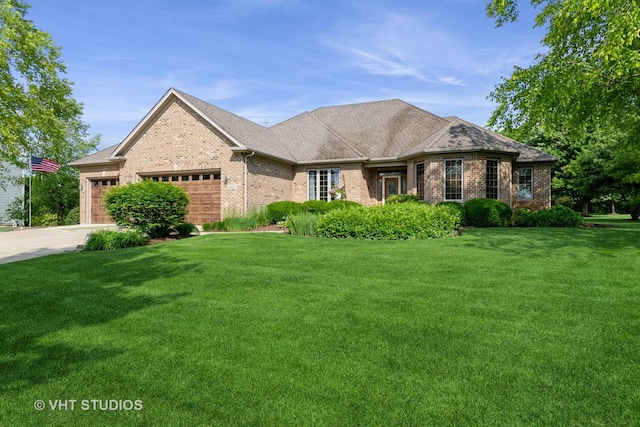 8820 Wilcox Ct, Newark, IL 60541 - view of front of home featuring brick siding, a garage, and a front yard