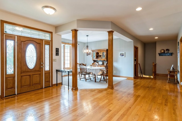8820 Wilcox Ct, Newark, IL 60541 - foyer featuring ornate columns, light wood-type flooring, a chandelier, and recessed lighting