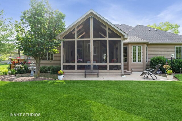 8820 Wilcox Ct, Newark, IL 60541 - back of property with a sunroom, a patio, a yard, and a shingled roof