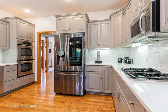8820 Wilcox Ct, Newark, IL 60541 - kitchen featuring appliances with stainless steel finishes, gray cabinetry, light countertops, light wood-style flooring, and recessed lighting