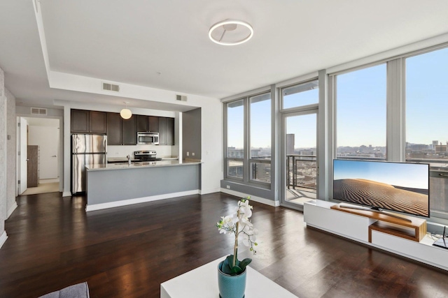 565 W Quincy St Unit 1606, Chicago, IL 60661 - living area featuring healthy amount of natural light, dark wood-style flooring, and baseboards