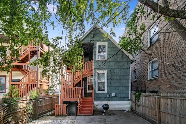 1340 E 76th St, Chicago, IL 60619 - rear view of property featuring stairway and a fenced backyard