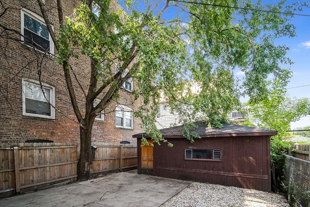 1340 E 76th St, Chicago, IL 60619 - fenced backyard featuring an outdoor structure and a patio