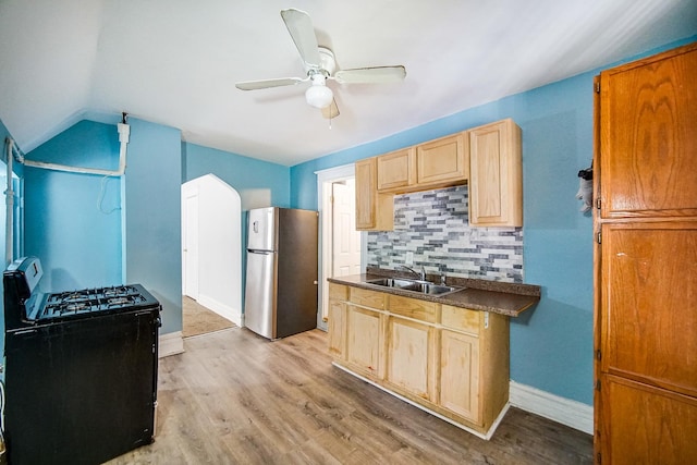 1340 E 76th St, Chicago, IL 60619 - kitchen featuring freestanding refrigerator, black range with gas stovetop, a sink, decorative backsplash, and ceiling fan