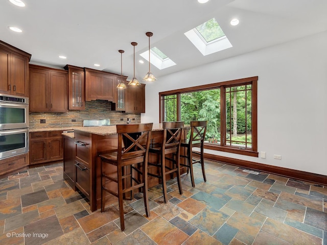 456 S Julian St, Naperville, IL 60540 - kitchen featuring stainless steel double oven, a skylight, tasteful backsplash, glass insert cabinets, and a kitchen bar