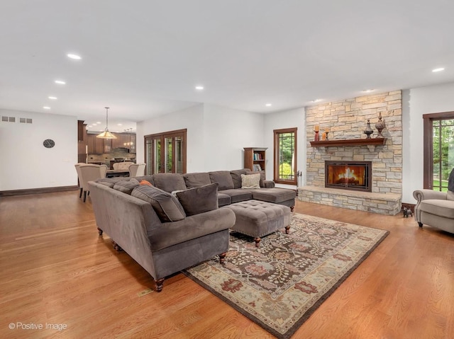 456 S Julian St, Naperville, IL 60540 - living room featuring recessed lighting, light wood-style floors, and a stone fireplace