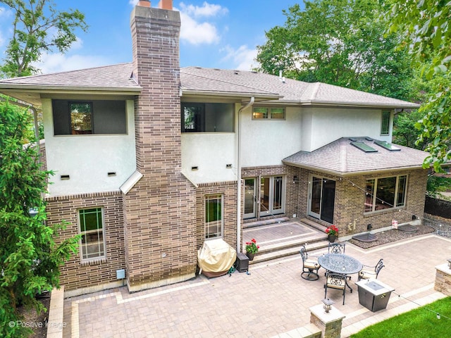 456 S Julian St, Naperville, IL 60540 - back of house with stucco siding, a patio area, a fire pit, and a chimney